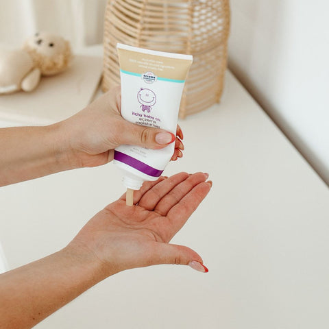 Smooth, creamy texture of eczema-friendly moisturiser shown on fingertips